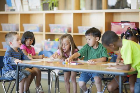 kindergartners sitting at a table 