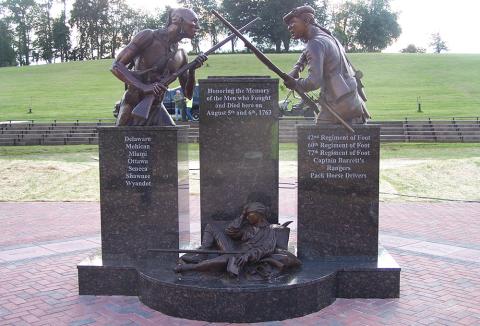 Image of memorial at Bushy Run. Features two combatants, one indigenous and one white. Names of tribes and regiments are inscribed.