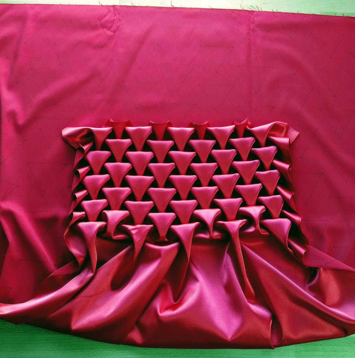 An image of origami tessellation techniques applied to fabric to make hearts!