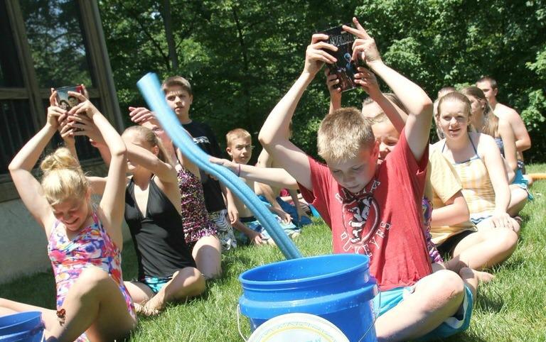 Kids playing a water relay race