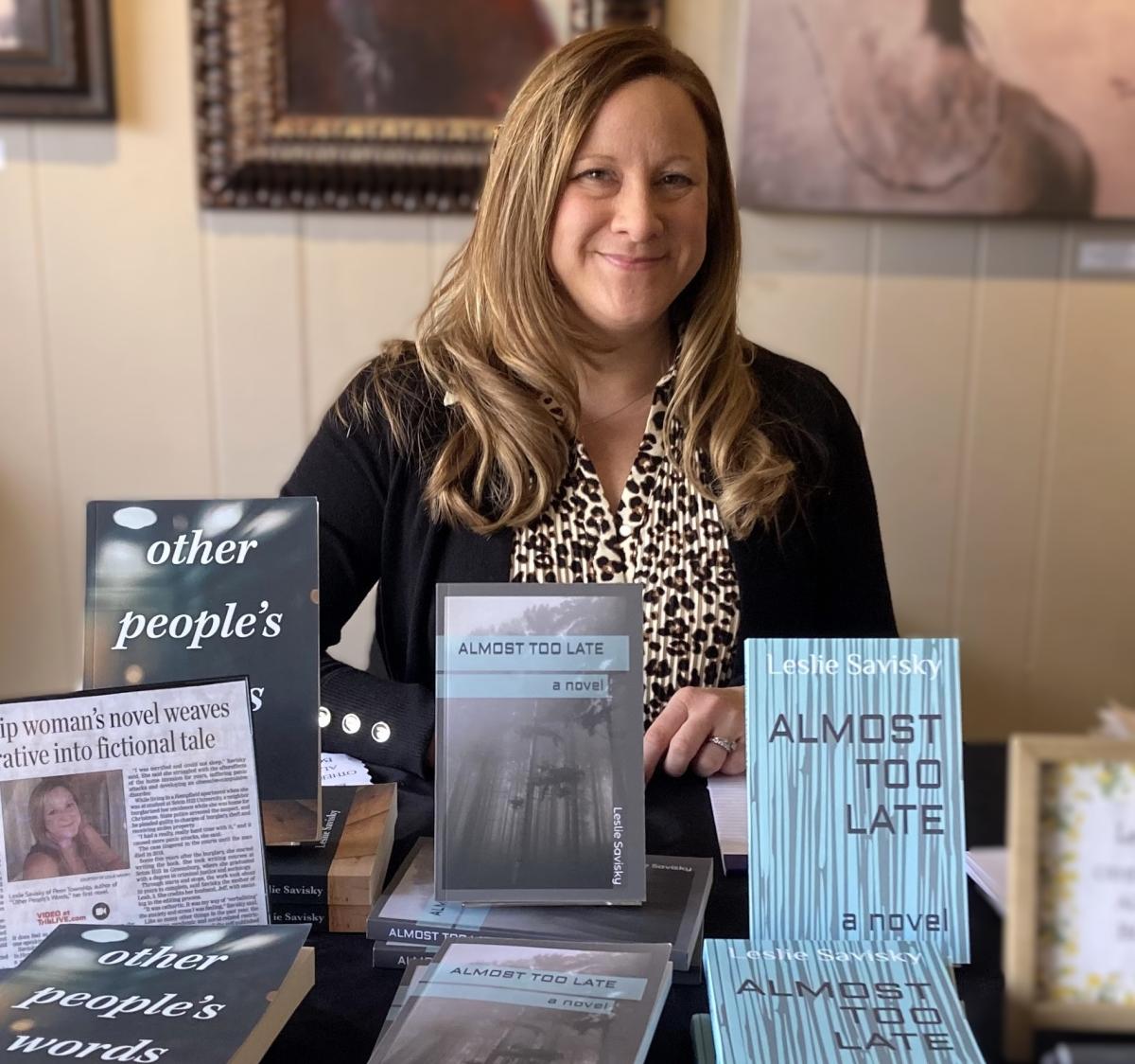 Image of author Leslie Savisky with copies of her books.