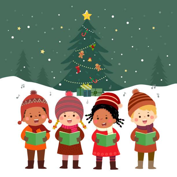 Four children singing in front of a Christmas tree