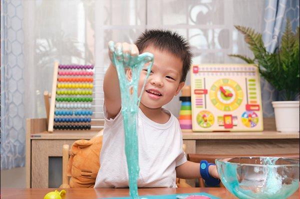 Toddler playing with slime
