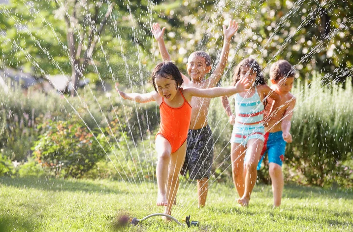 Kids playing in a sprinkler
